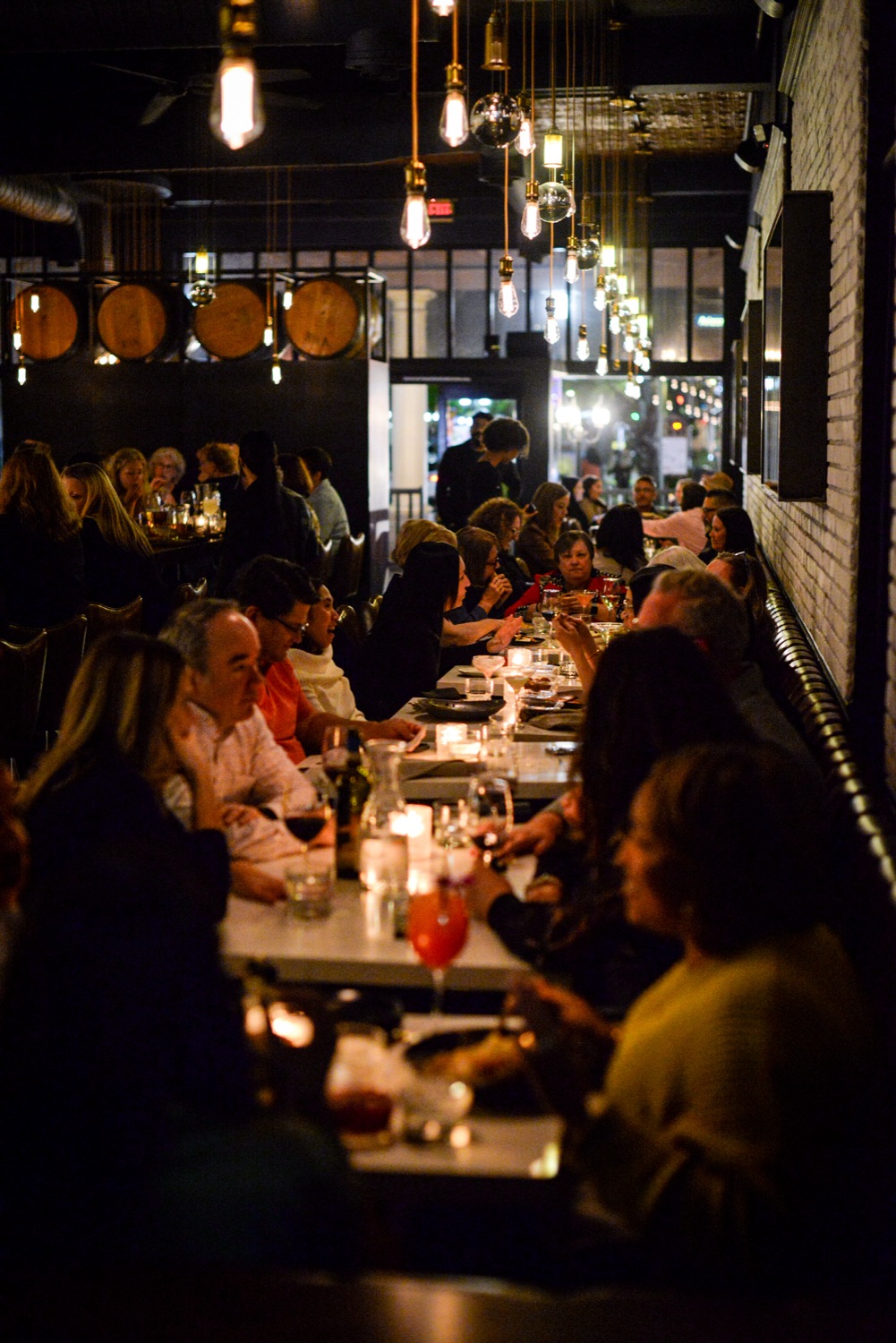 Guests gathered around candlelit tables in the BlackSheep dining room